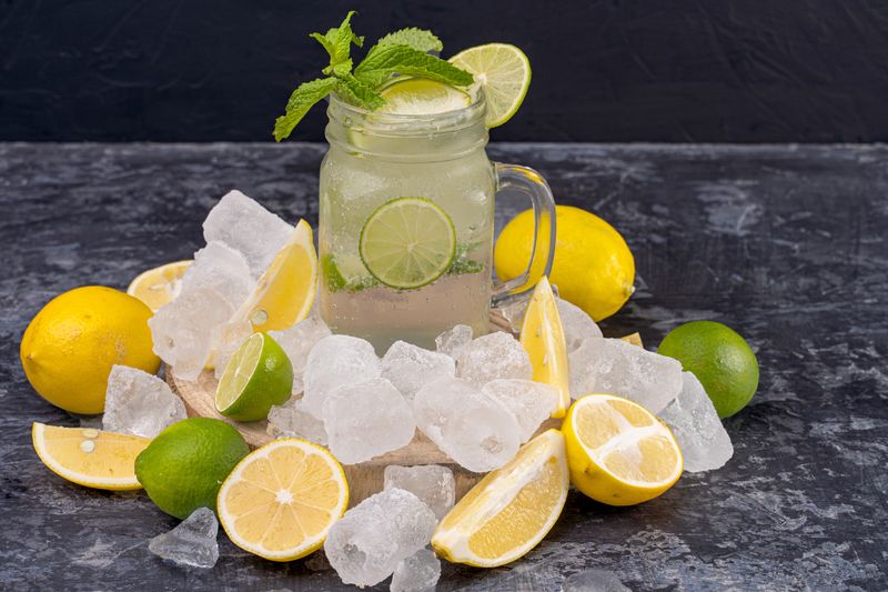 Fresh lemonade in glass with ice and lemon slices